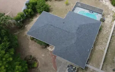An aerial view of a house with a pool in the backyard.
