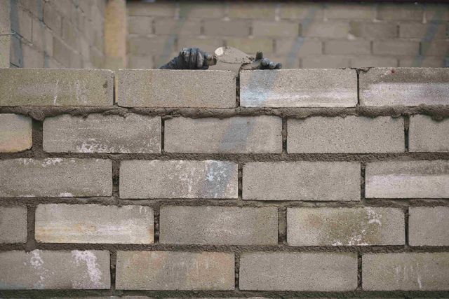 A bricklayer building a wall