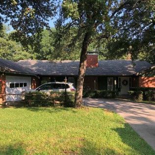 A house with a car parked in front of it.