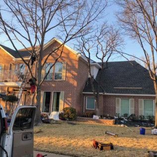 A truck is parked in front of a brick house.