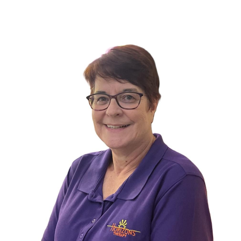 A woman wearing glasses and a black shirt smiles for the camera
