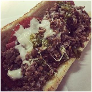 A salad with lettuce, eggs, peppers, carrots and olives in plastic containers.