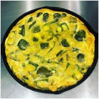 peppers and eggs sitting in a skillet on a table