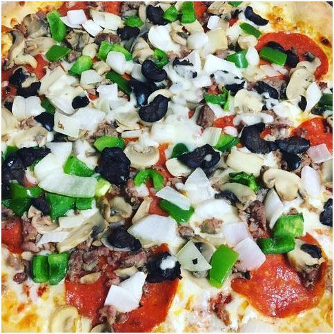 A pizza with a lot of toppings on it