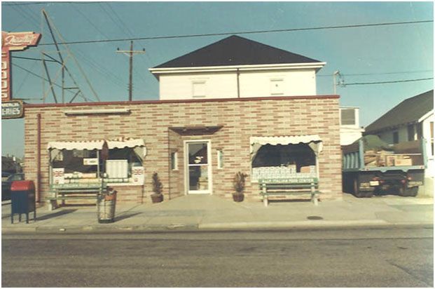 A brick building with a coca cola sign in the background