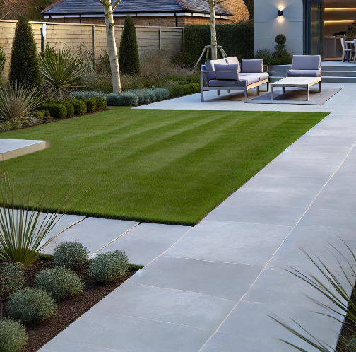 A brick walkway next to a lush green field
