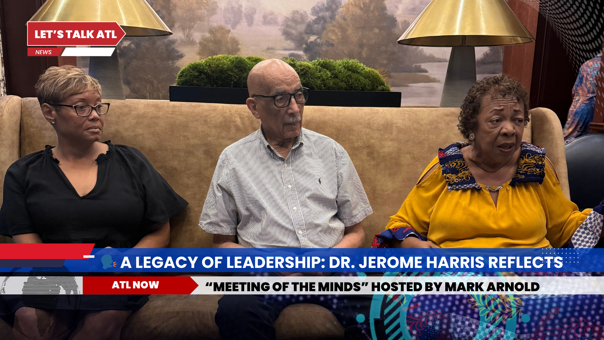 Three people seated on a couch, likely during a TV interview. Text overlay reads