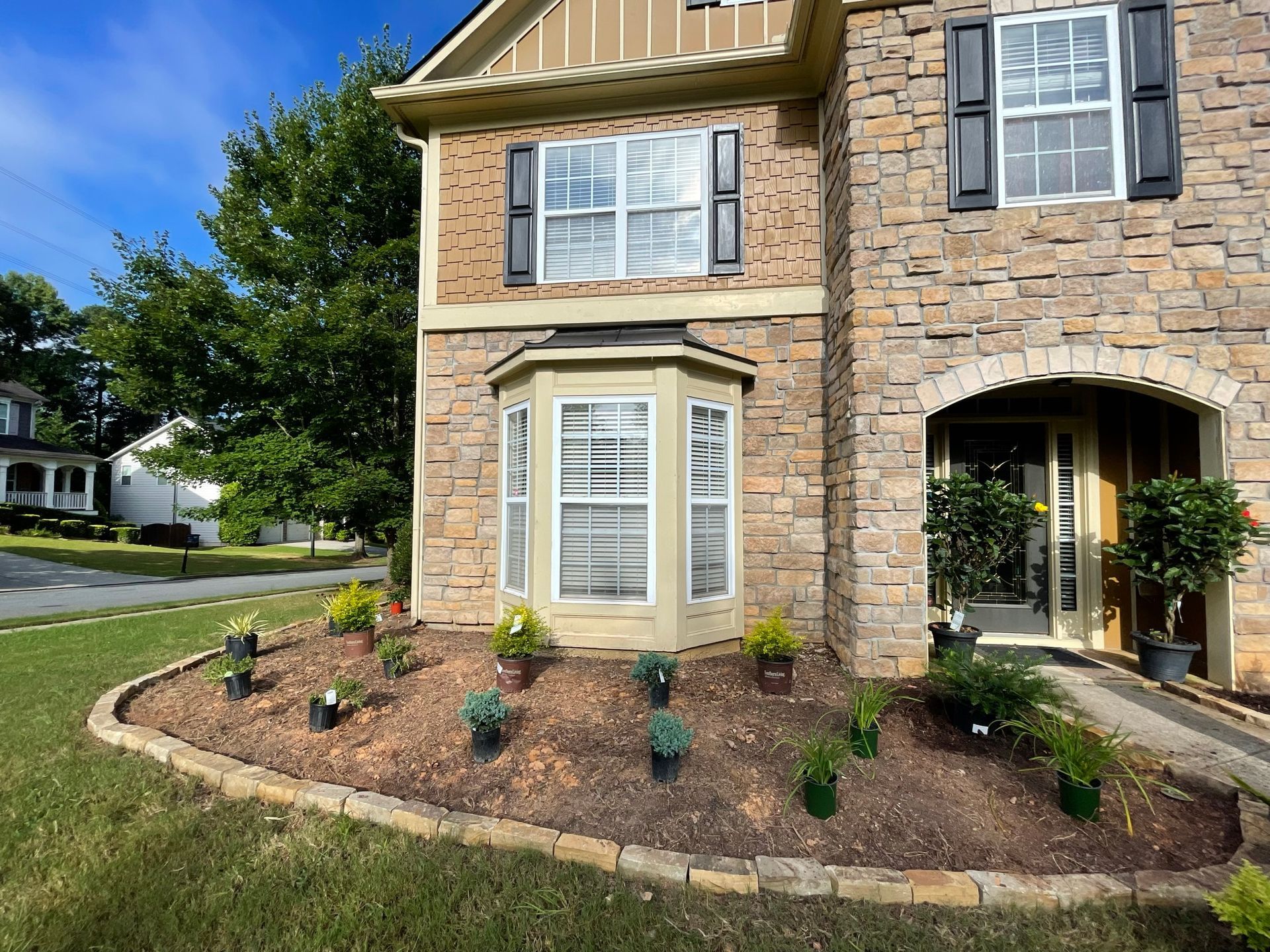 A large brick house with a garden in front of it