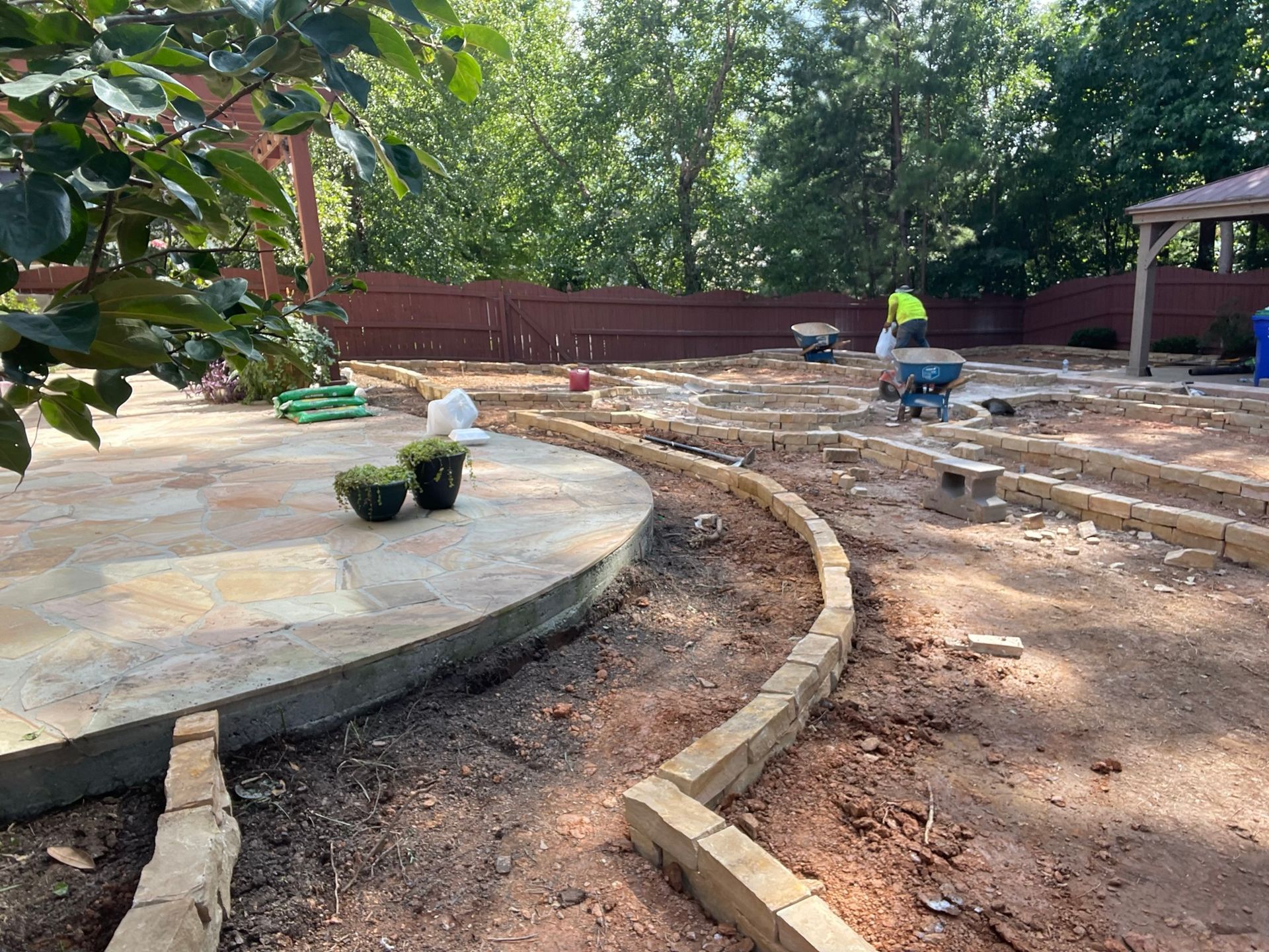 A concrete patio is being built in a backyard.