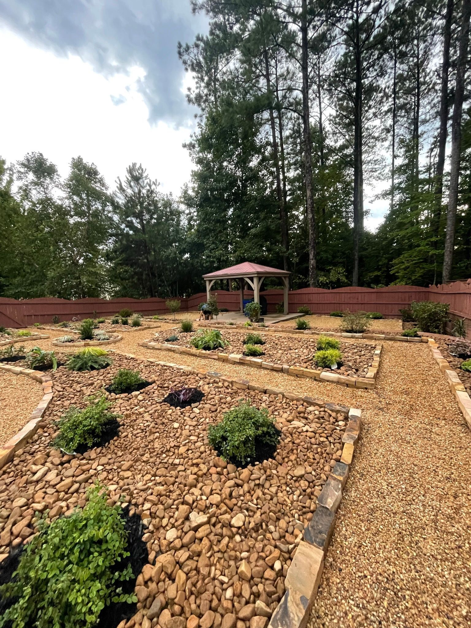 There is a gazebo in the middle of the garden.