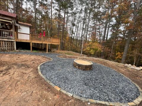 There is a fire pit in the middle of the yard.