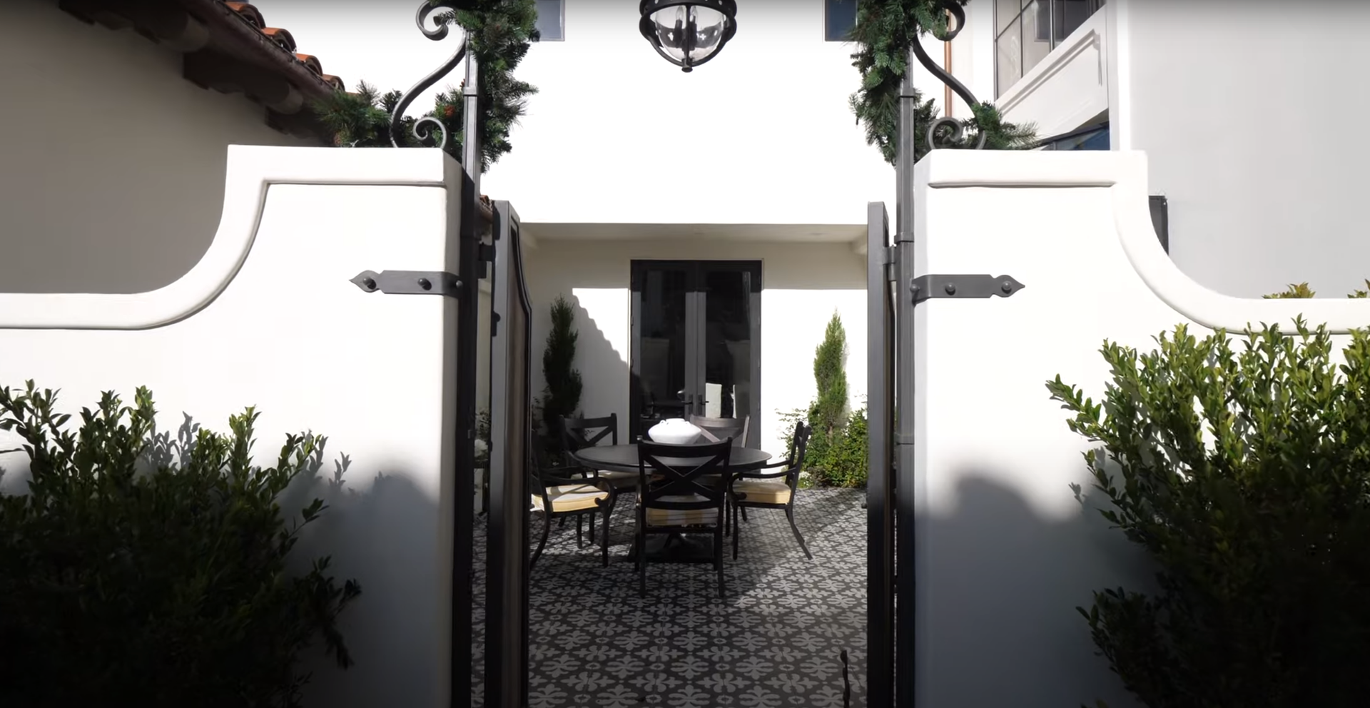 A white house with a black gate leading to it