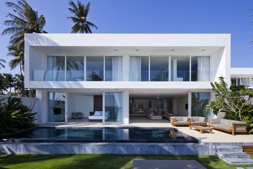 A large white house with a swimming pool in the backyard