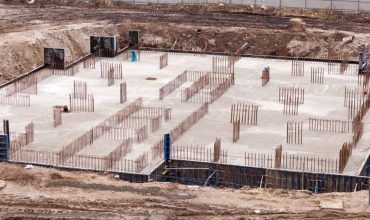 An aerial view of a concrete foundation of a building under construction.