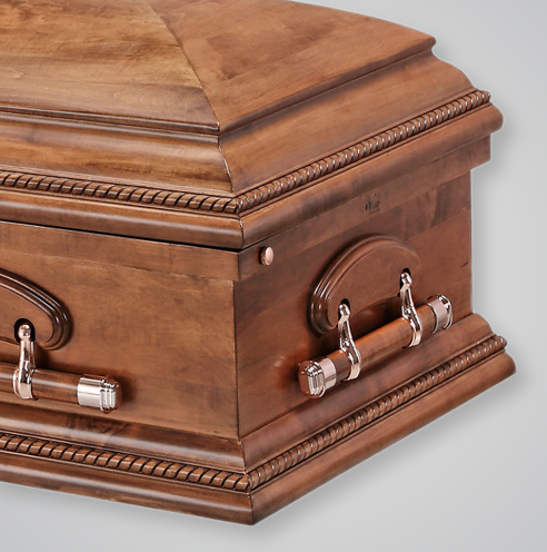 A close up of a wooden coffin with silver handles