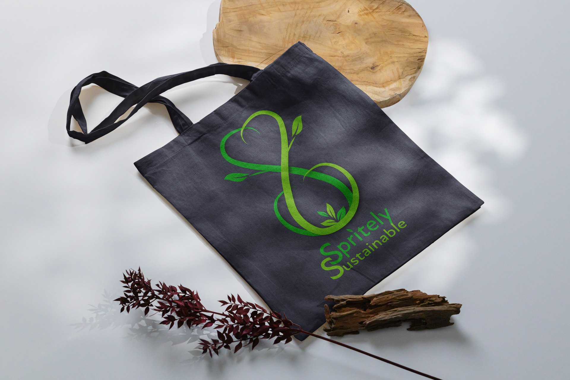 A black tote bag with a green infinity symbol on it