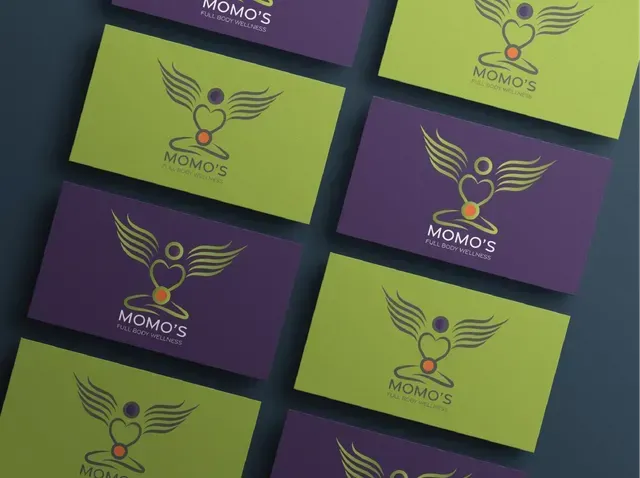 A bunch of momo 's business cards are stacked on top of each other