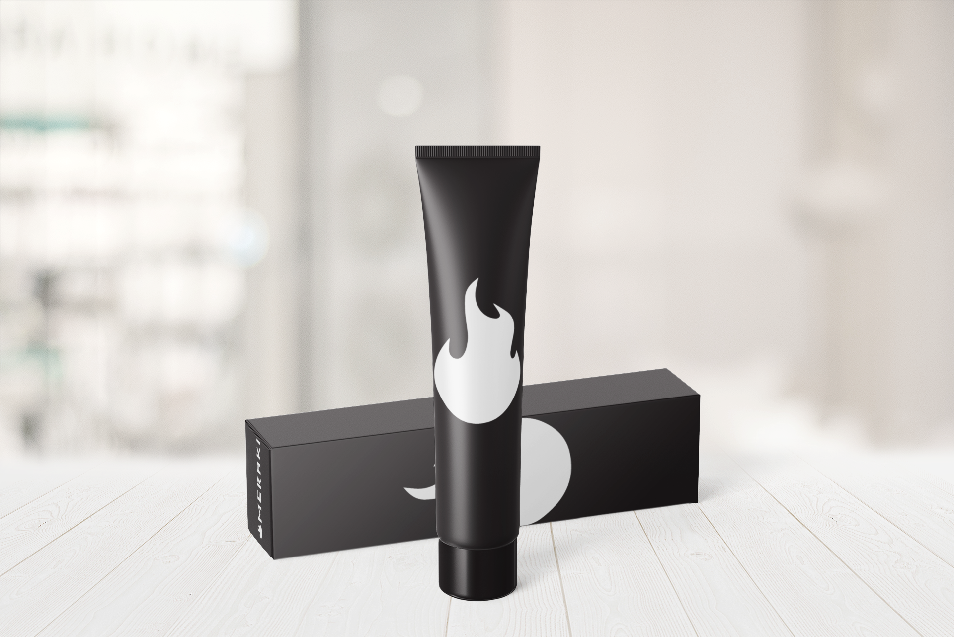 A tube of toothpaste is sitting on a table next to a box.