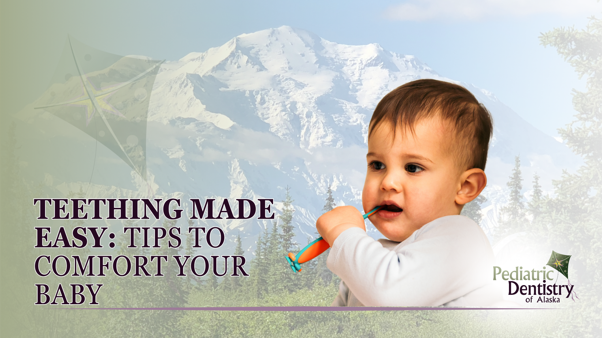 A baby is eating a carrot with a mountain in the background.