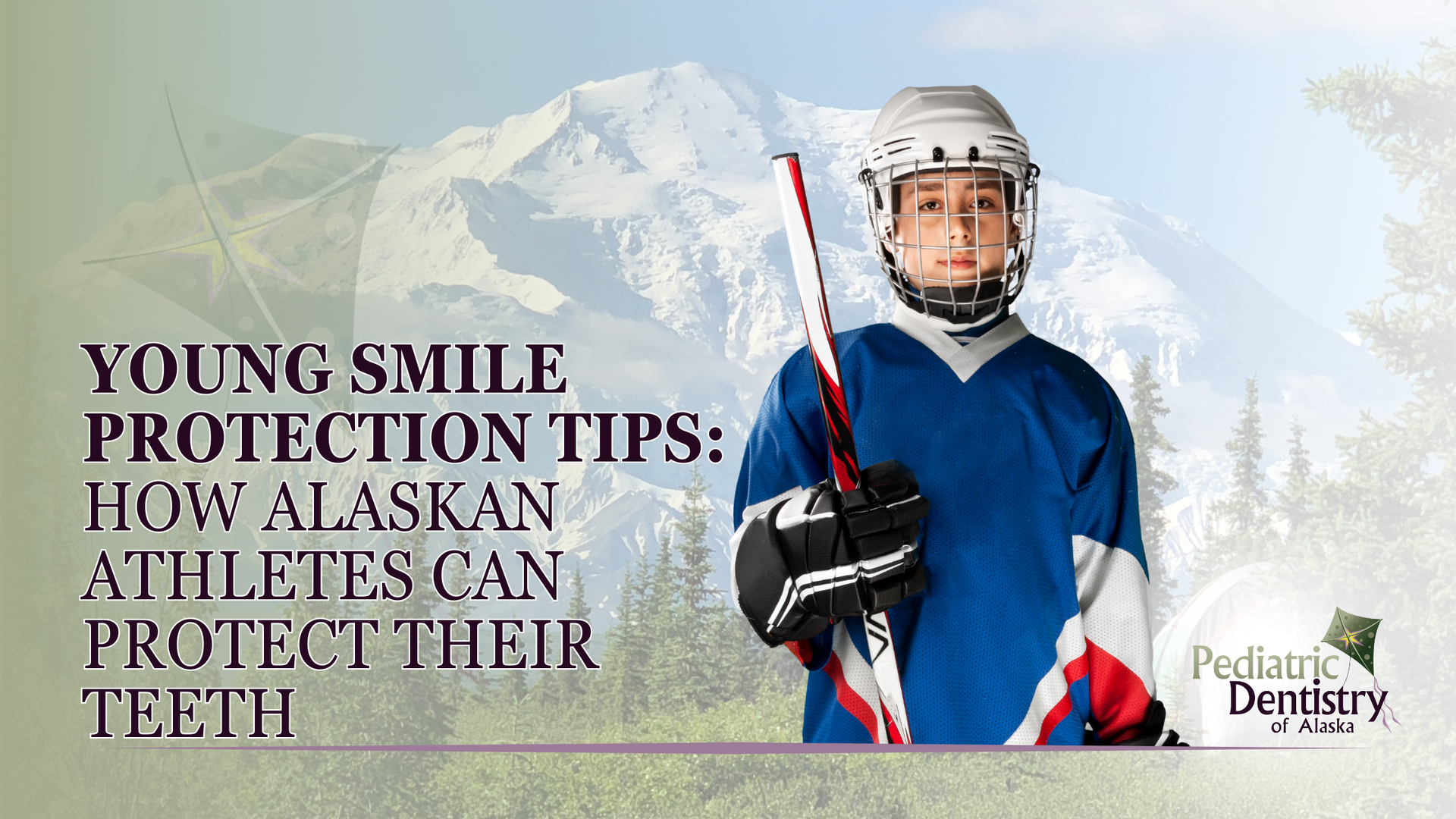 A young hockey player is holding a hockey stick in front of a mountain.