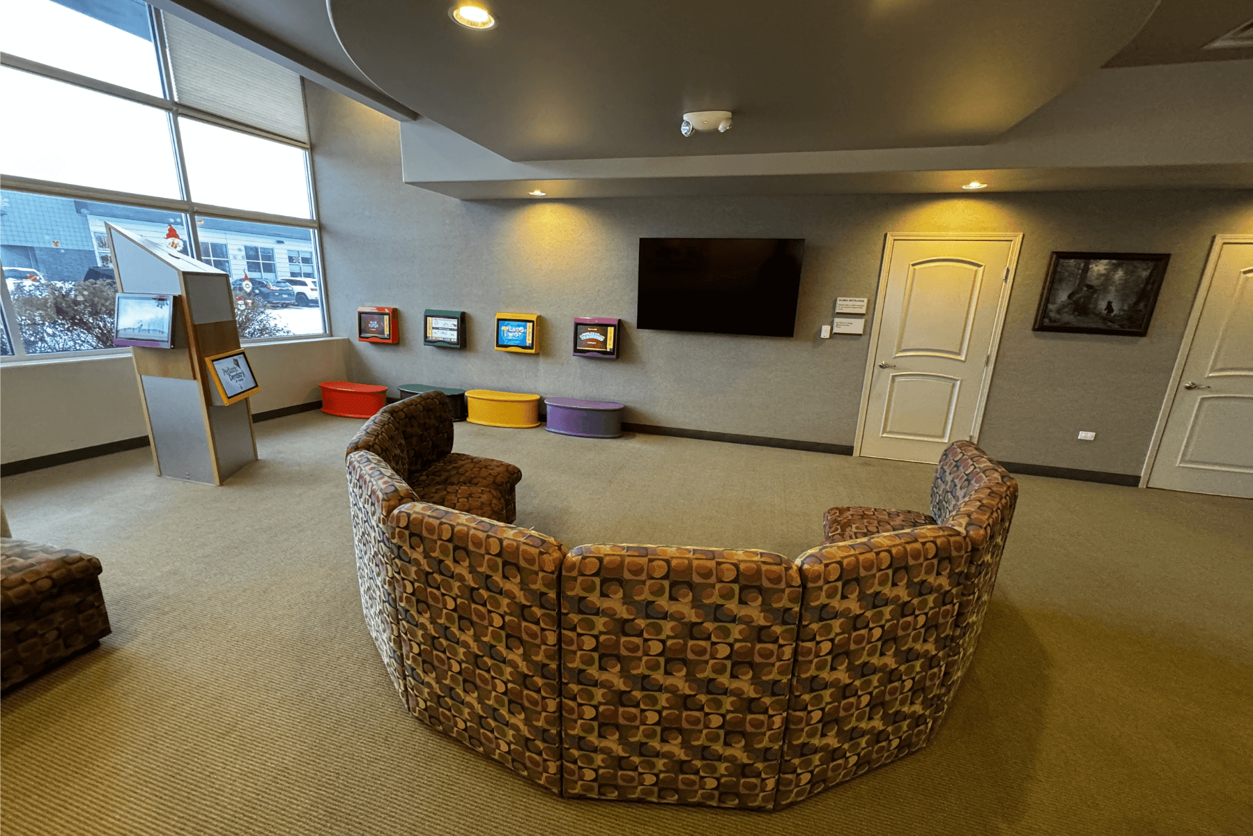 a living room with a couch , chairs and a flat screen tv | Pediatric Dentistry of Alaska | Best Pediatric Dentist In Wasilla and Palmer, Alaska