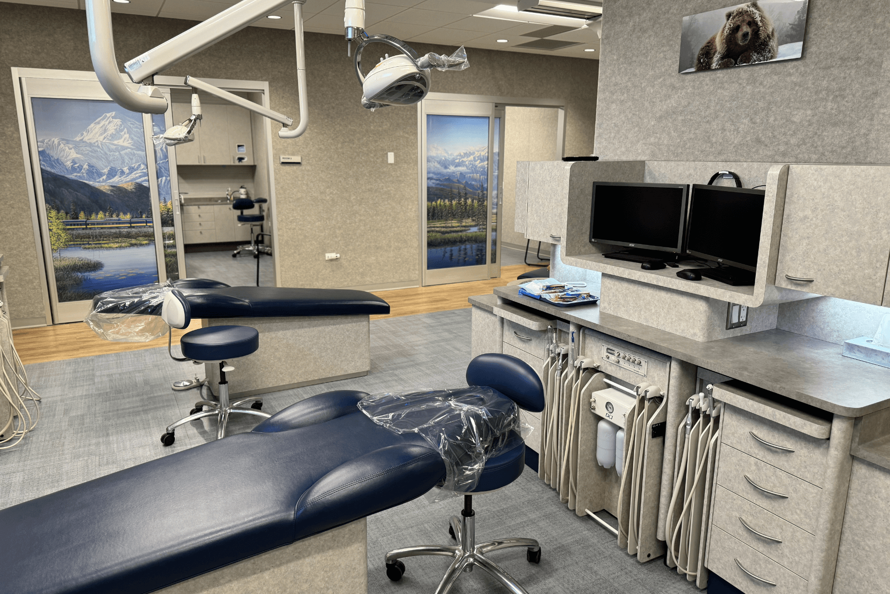 a dental office with two dental chairs and two monitors | Pediatric Dentistry of Alaska | Best Pediatric Dentist In Wasilla and Palmer, Alaska