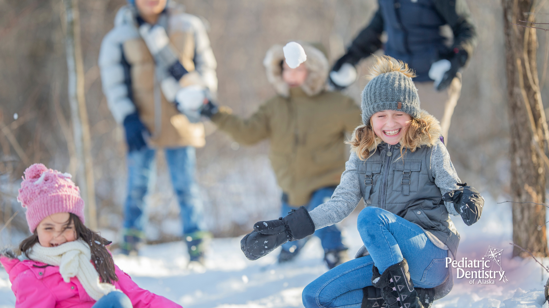 A group of people are playing in the snow.