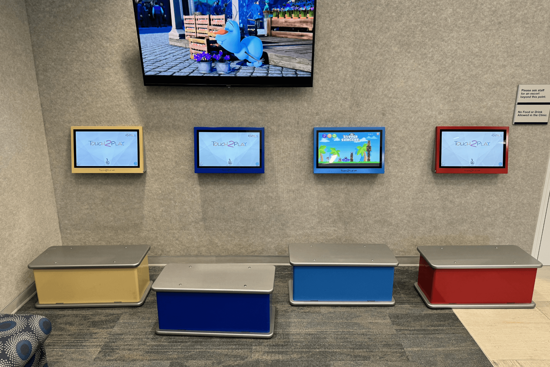 a row of colorful benches under a flat screen tv | Pediatric Dentistry of Alaska | Best Pediatric Dentist In Wasilla and Palmer, Alaska