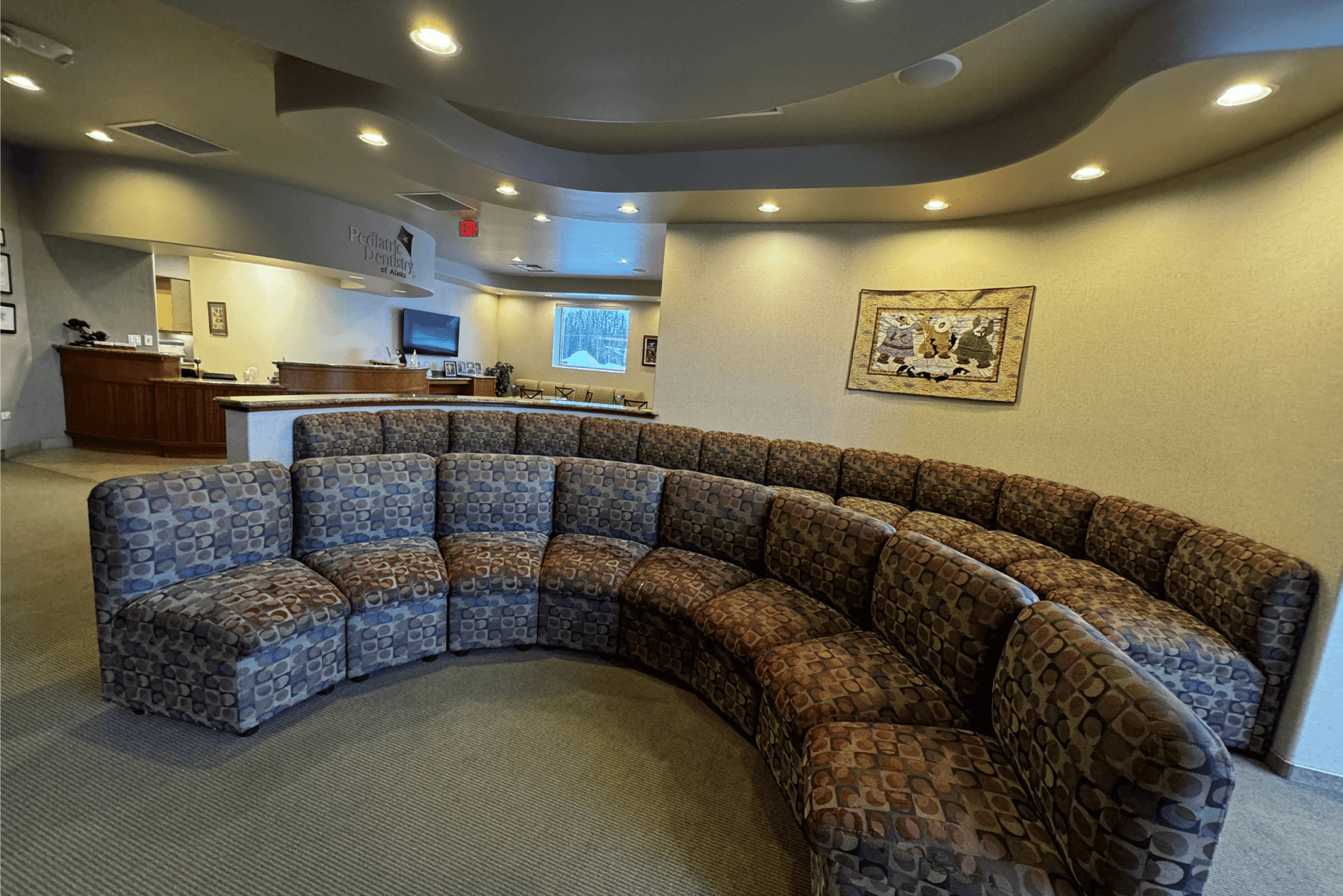 a waiting room with a large curved couch and chairs | Pediatric Dentistry of Alaska | Best Pediatric Dentist In Wasilla and Palmer, Alaska
