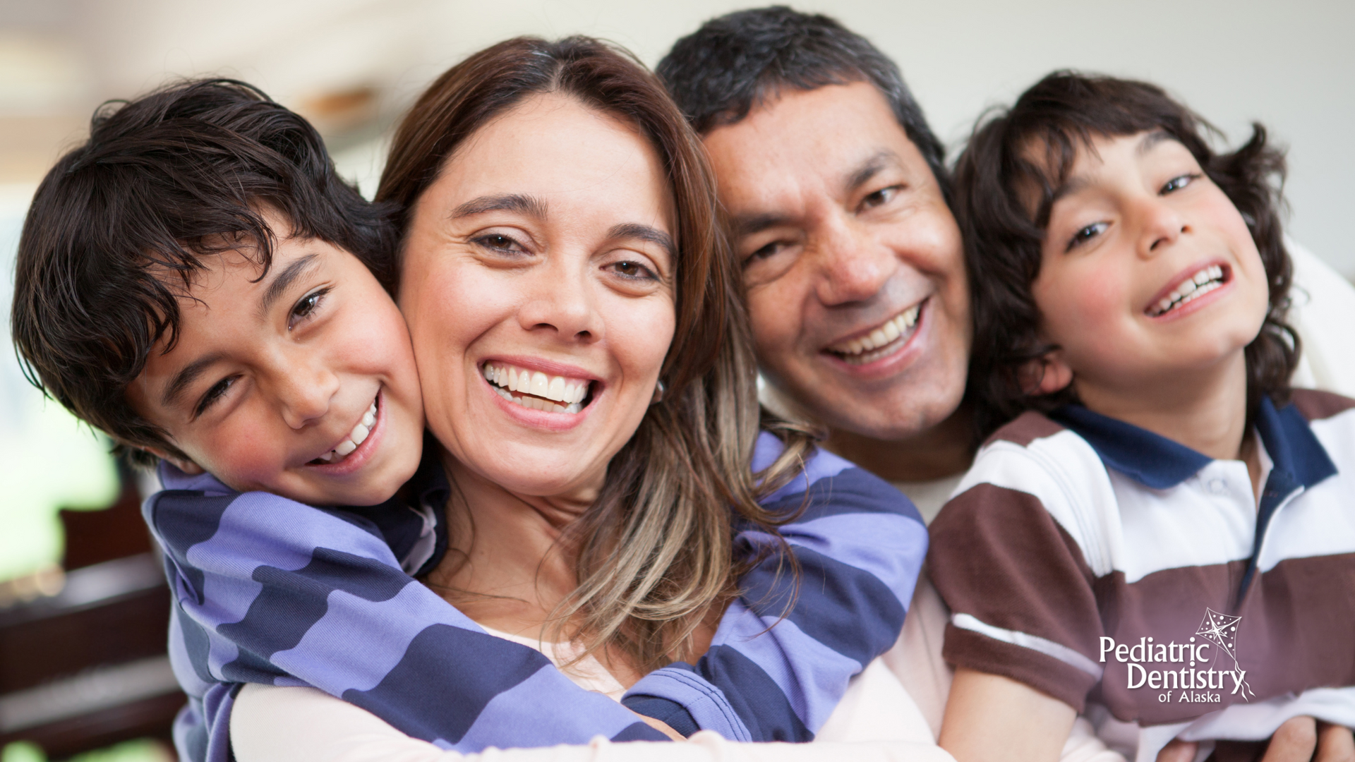 A family is posing for a picture together and smiling.