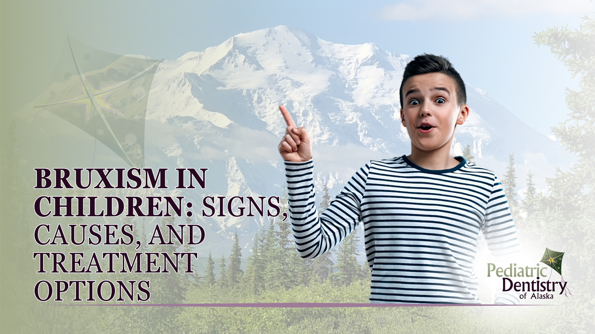 A young boy is standing in front of a mountain pointing up.