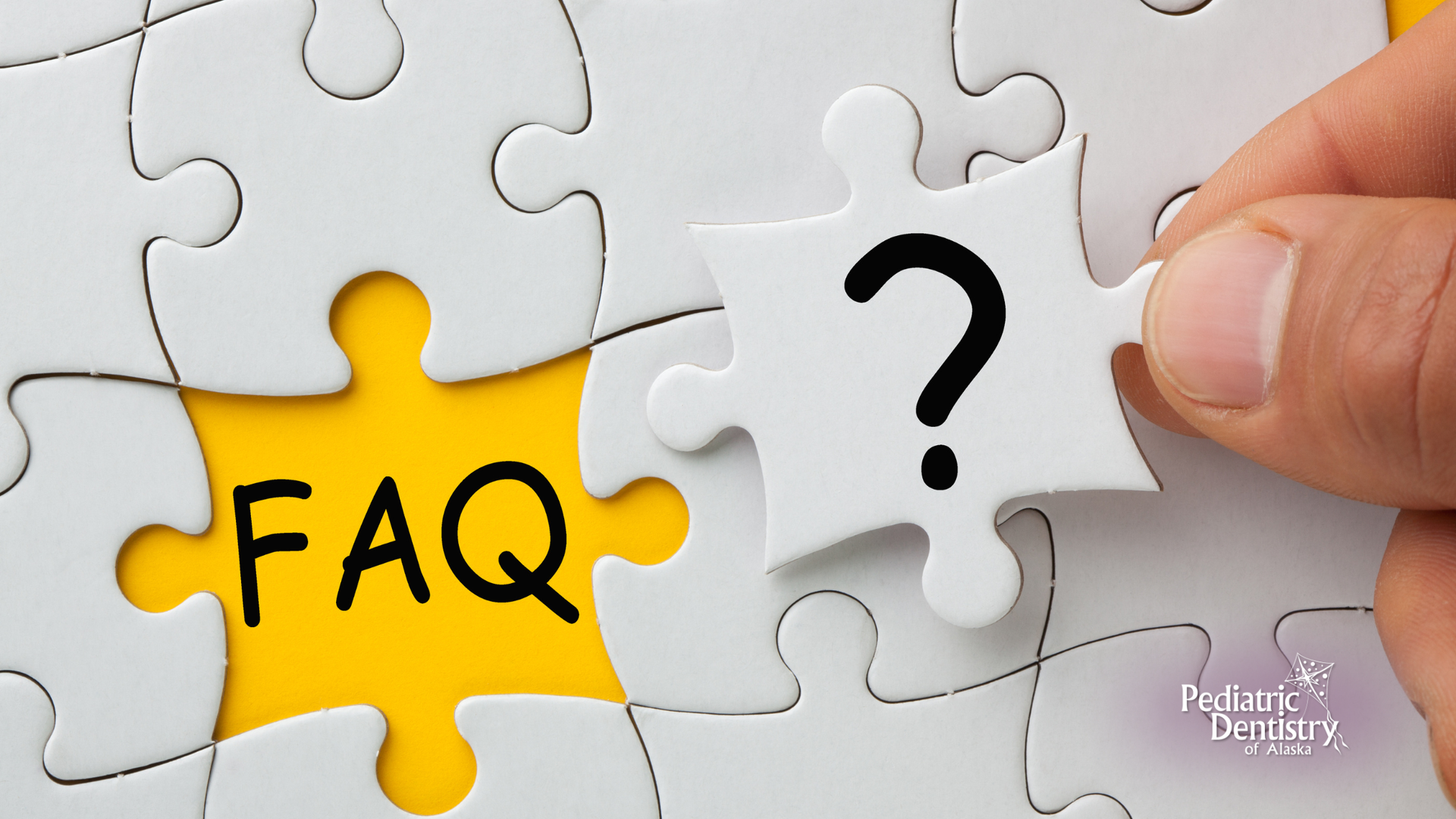 Hand placing a puzzle piece with a question mark over the word