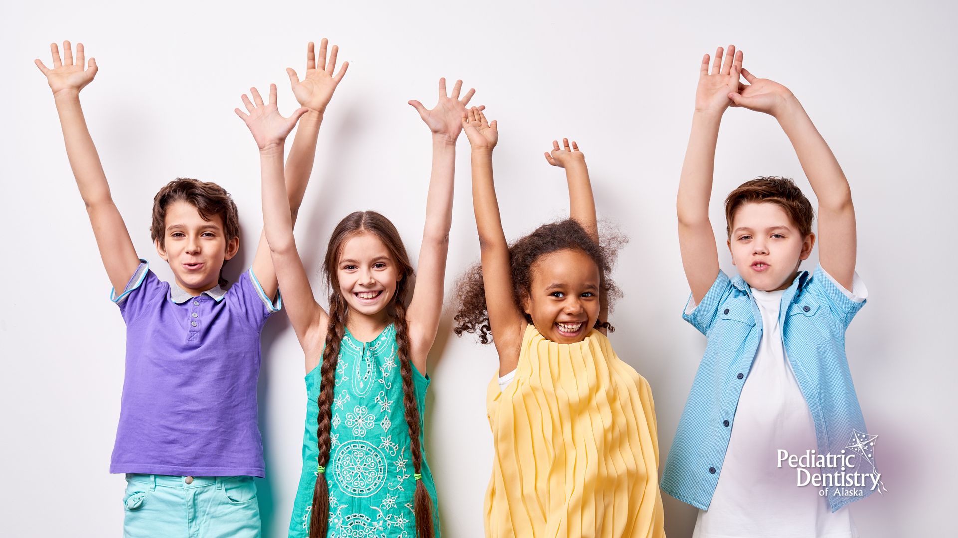 Four diverse children with arms raised, smiling against a white background.