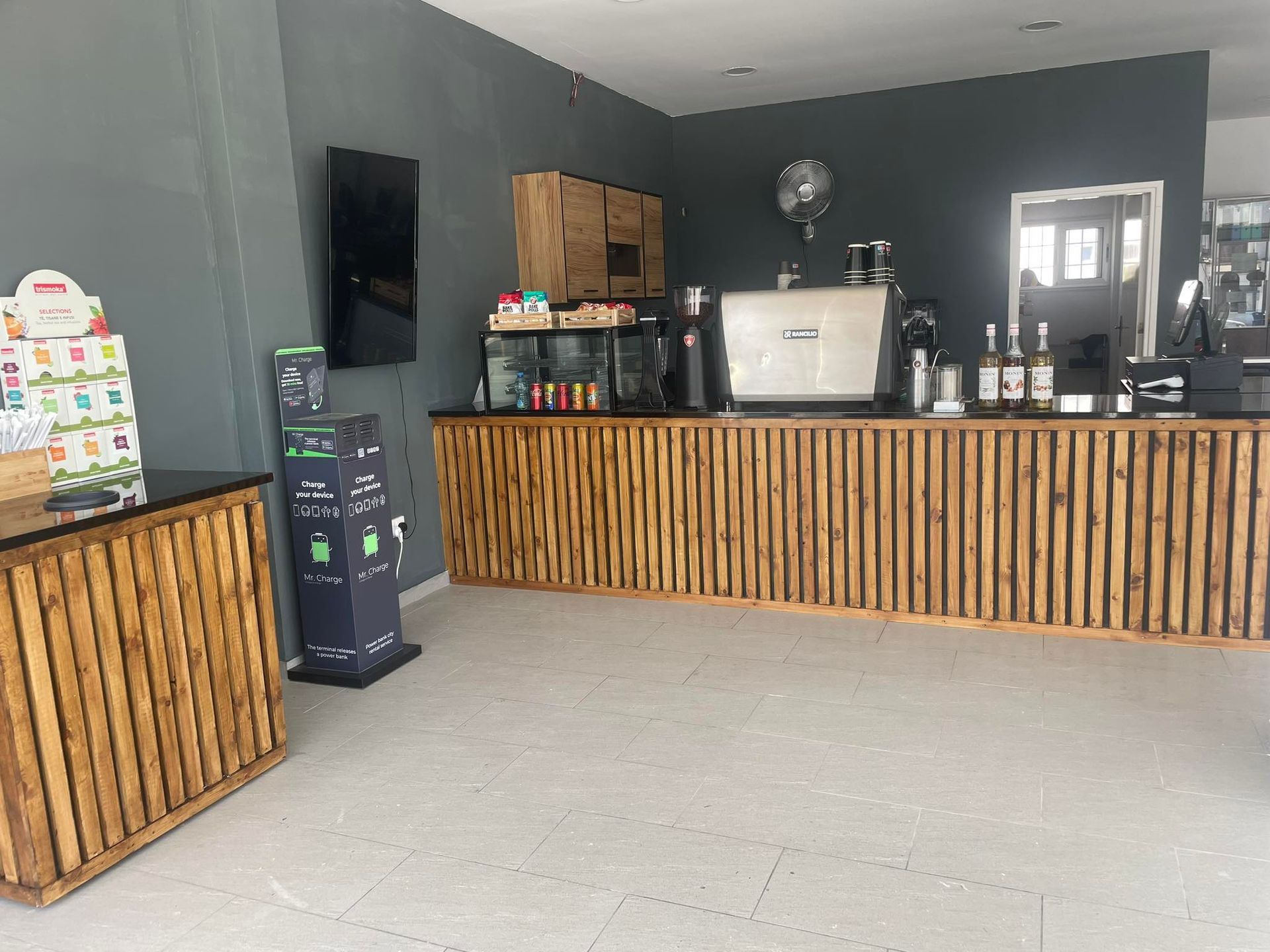 A large room with a lot of wooden tables and counters.