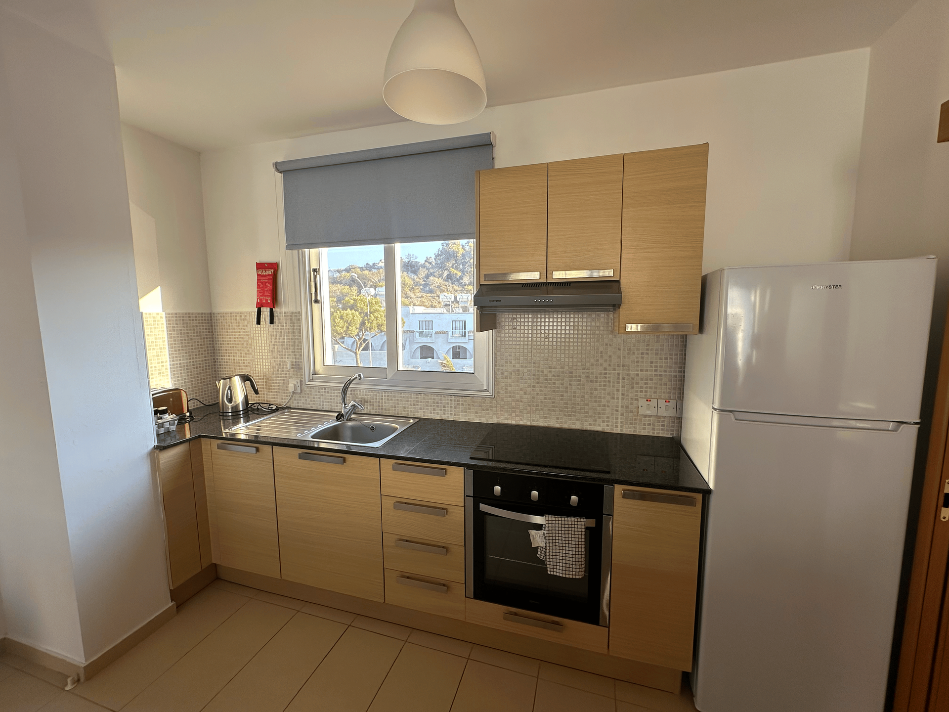 A kitchen with wooden cabinets and a white refrigerator