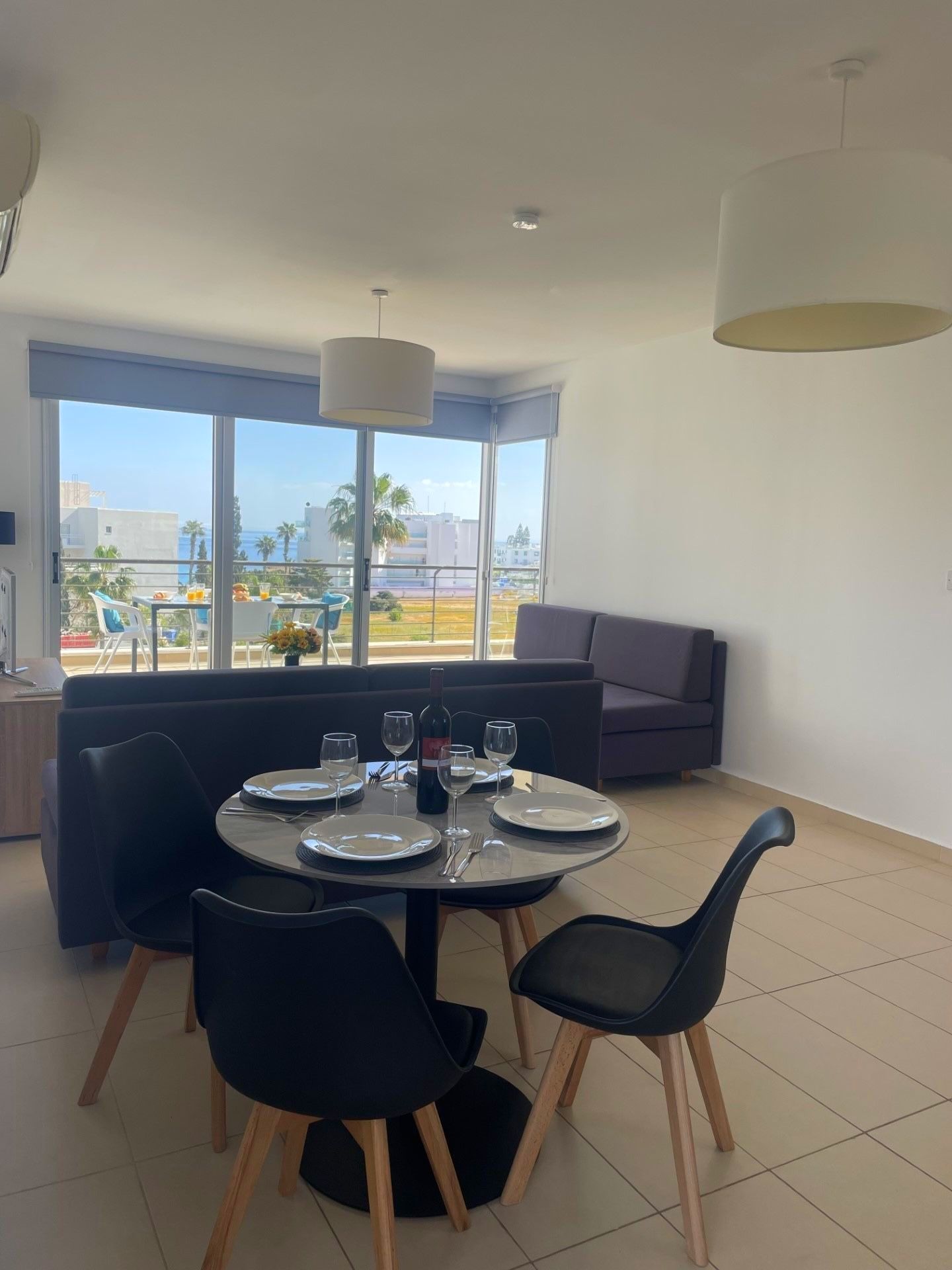 A living room with a table and chairs and a couch.