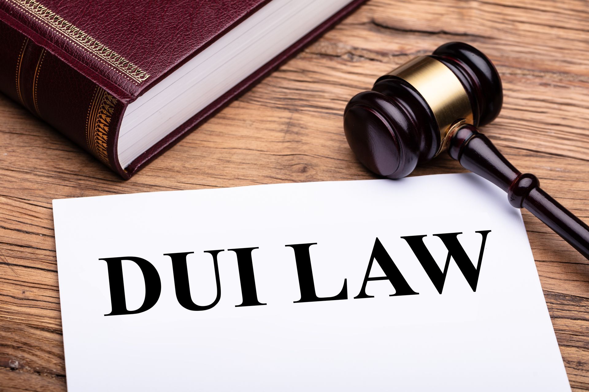 Golden sign with DUI law text and wooden gavel.