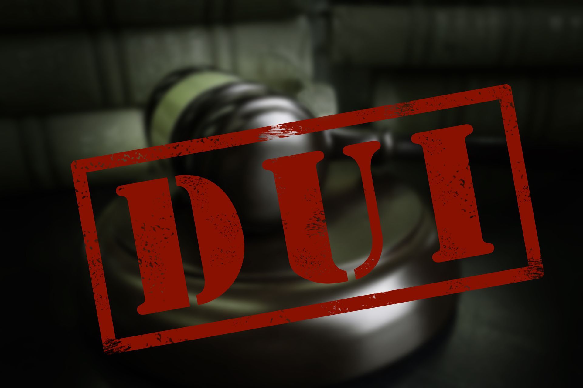 A blurred gavel with a bold red “DUI” stamp across the front.