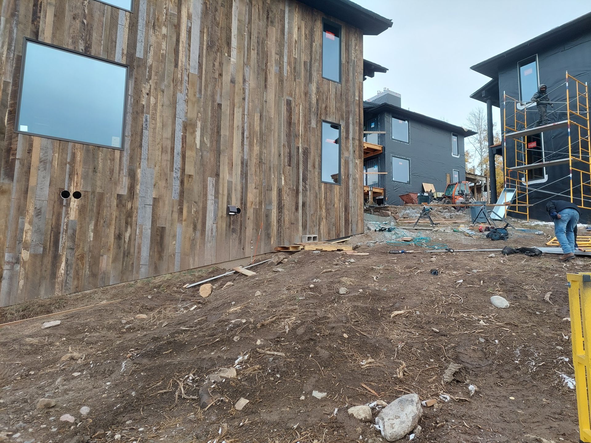 A building with is being built next to existing homes.