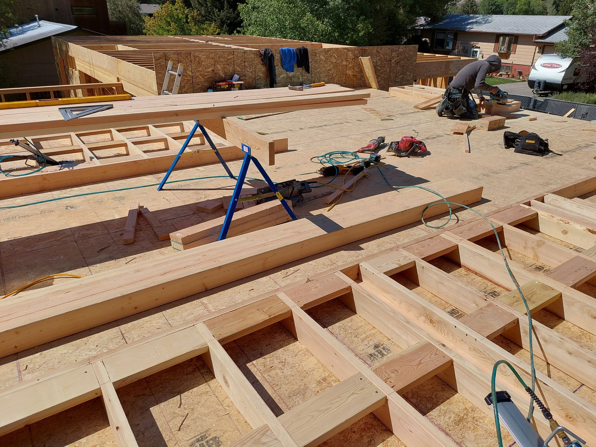 A man is working on the roof of a house under construction.