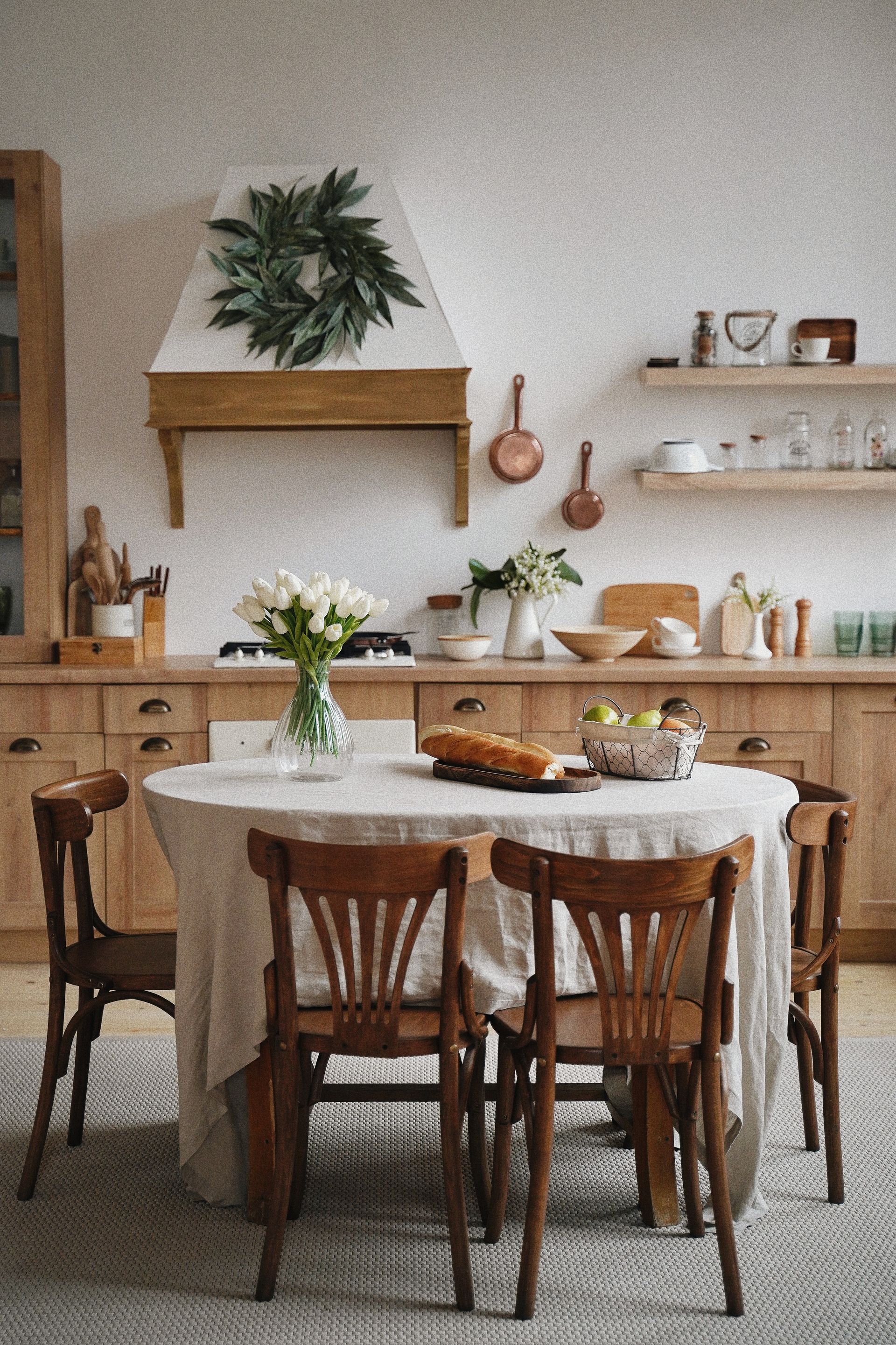 A kitchen with a table and chairs