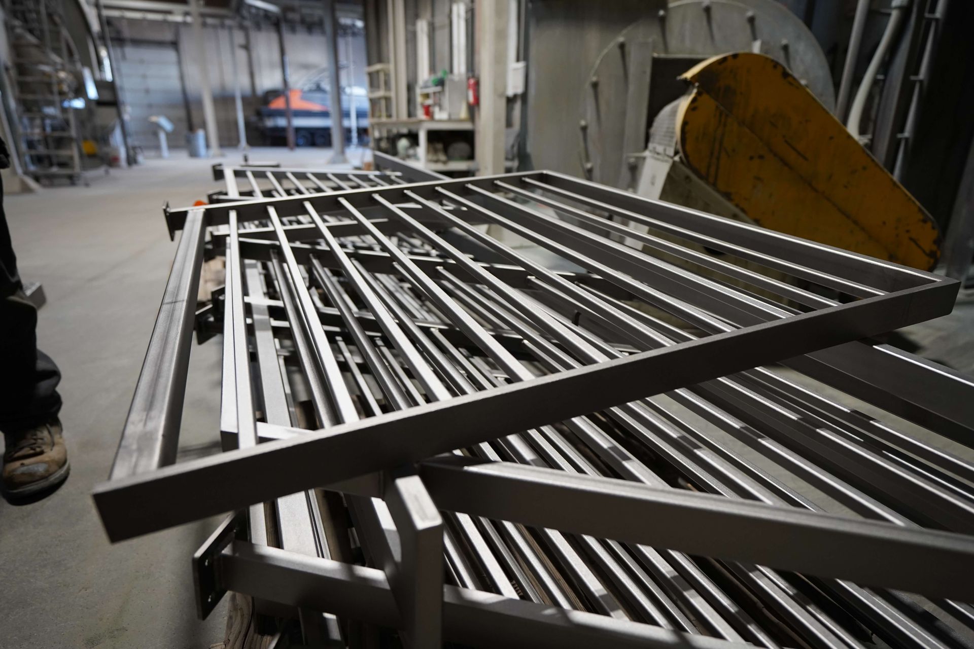 A bunch of metal bars are stacked on top of each other in a room.