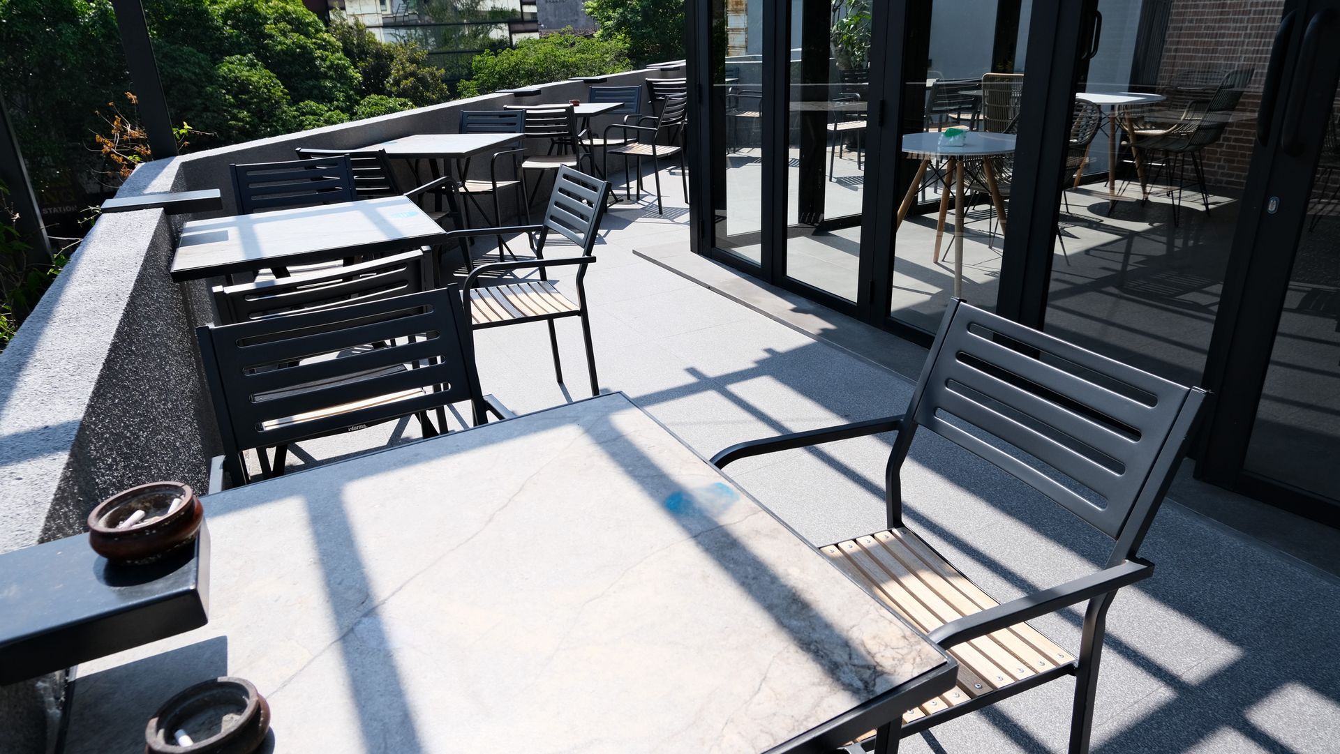 Outdoor cafe with tables and chairs that have been powder coated on a sunny rooftop patio.