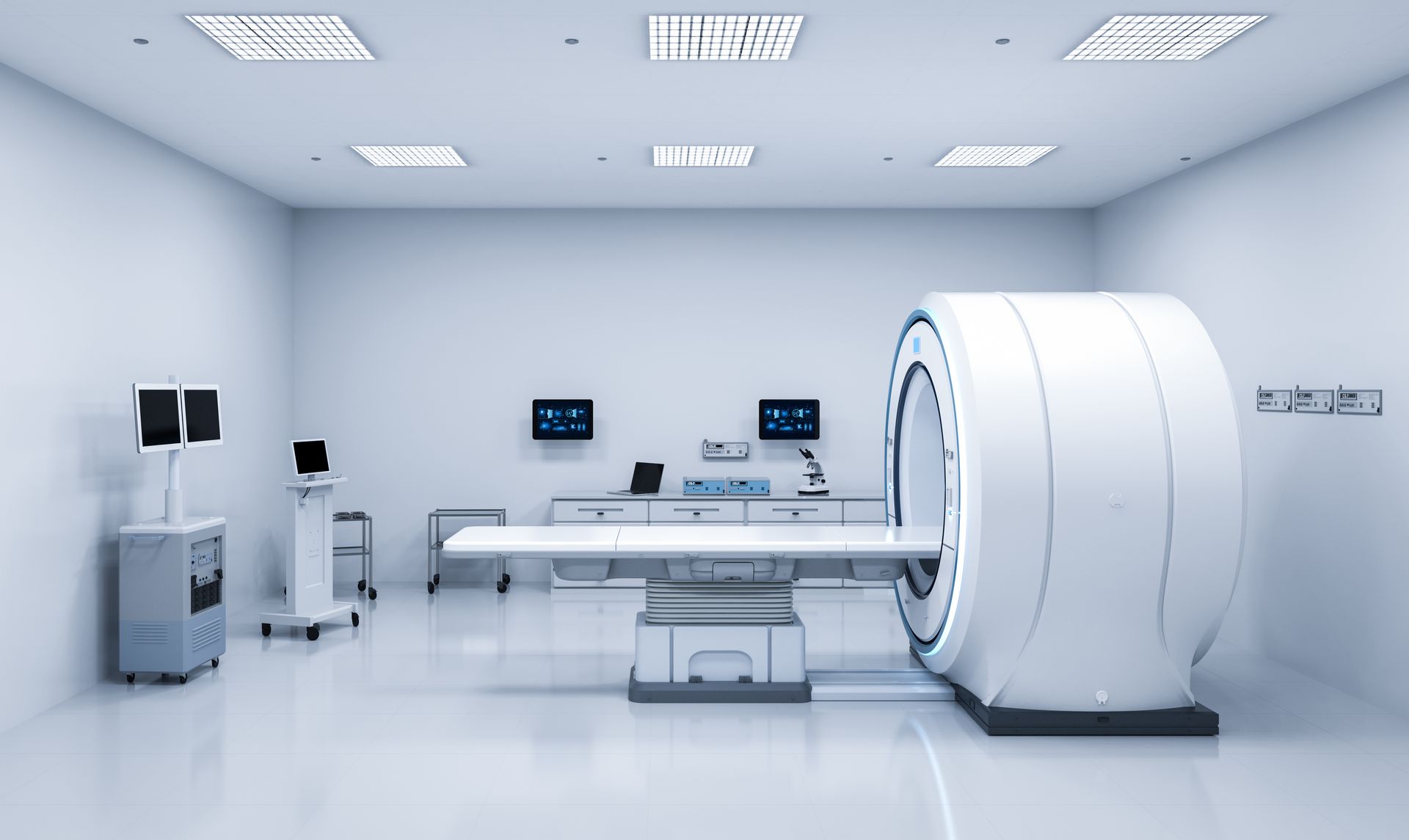 MRI machine in a bright, white medical room with control consoles and equipment.