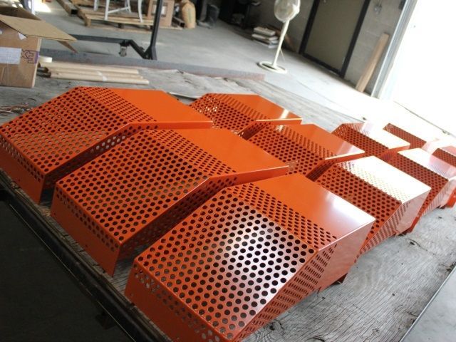 A bunch of orange boxes with holes in them