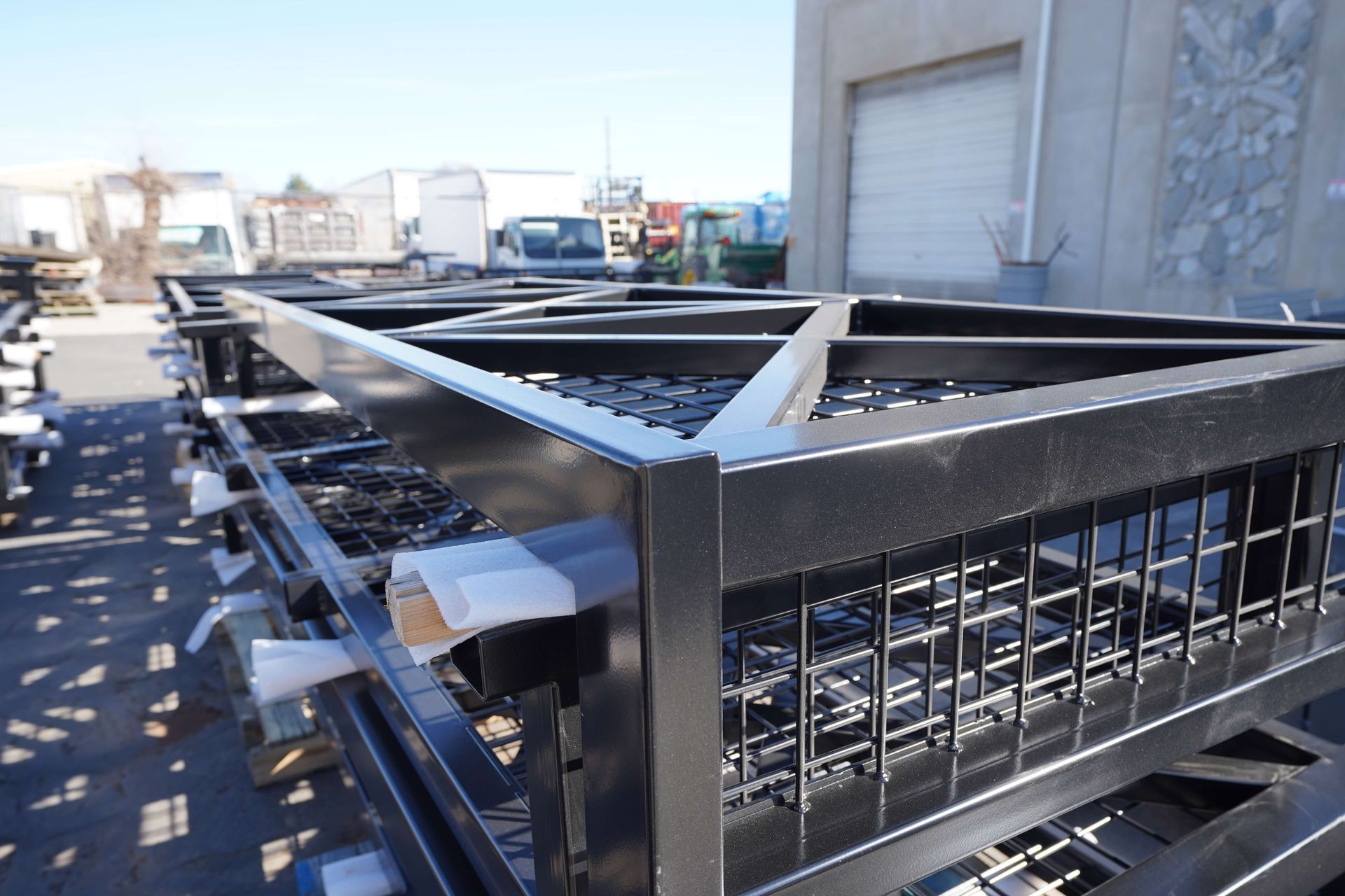 A black metal structure is sitting in front of a building.