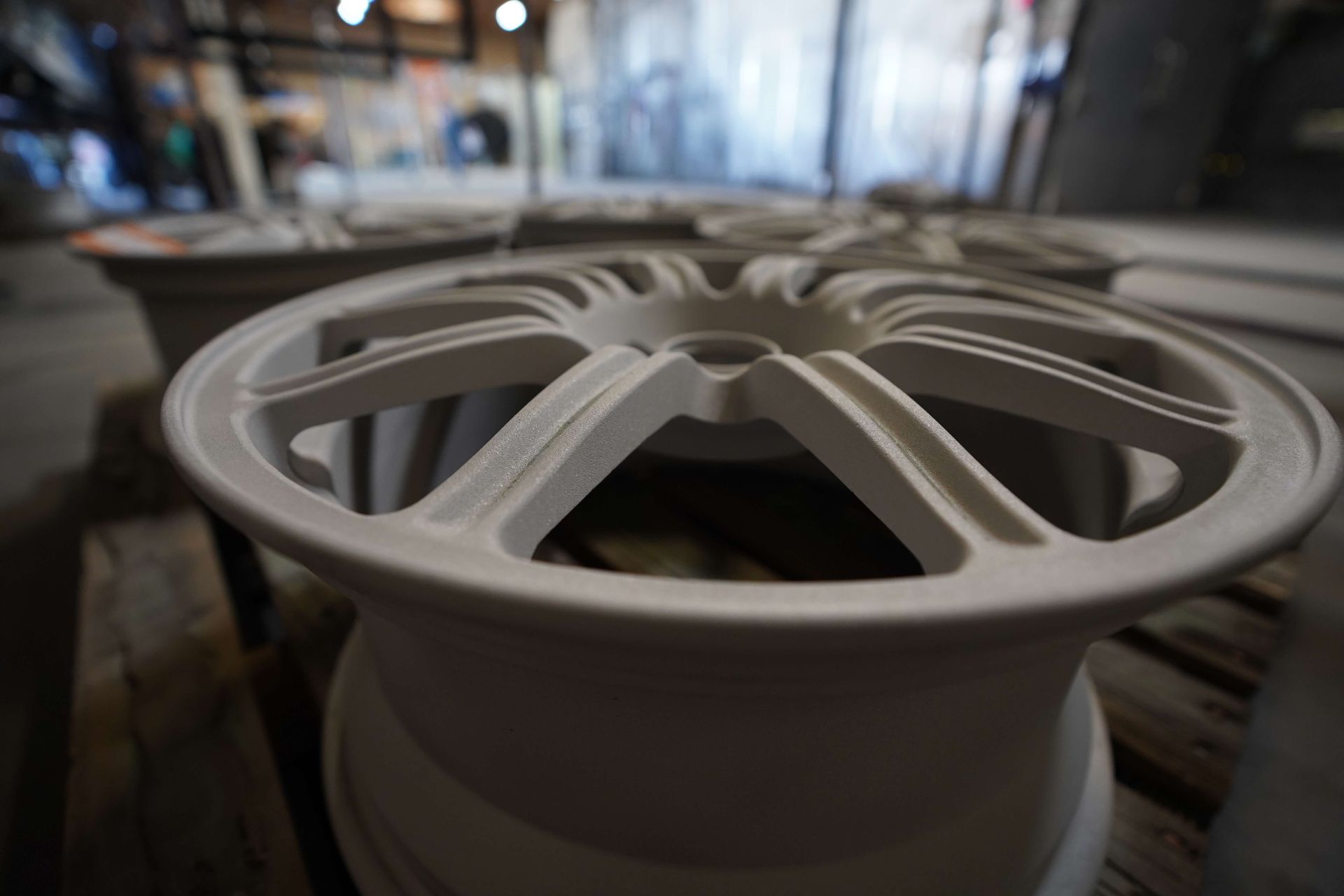 A close up of a white wheel sitting on top of a wooden table.