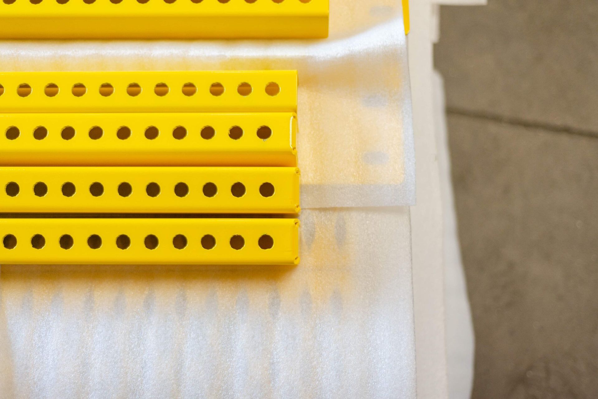 A bunch of yellow pieces with holes in them are sitting on a table.