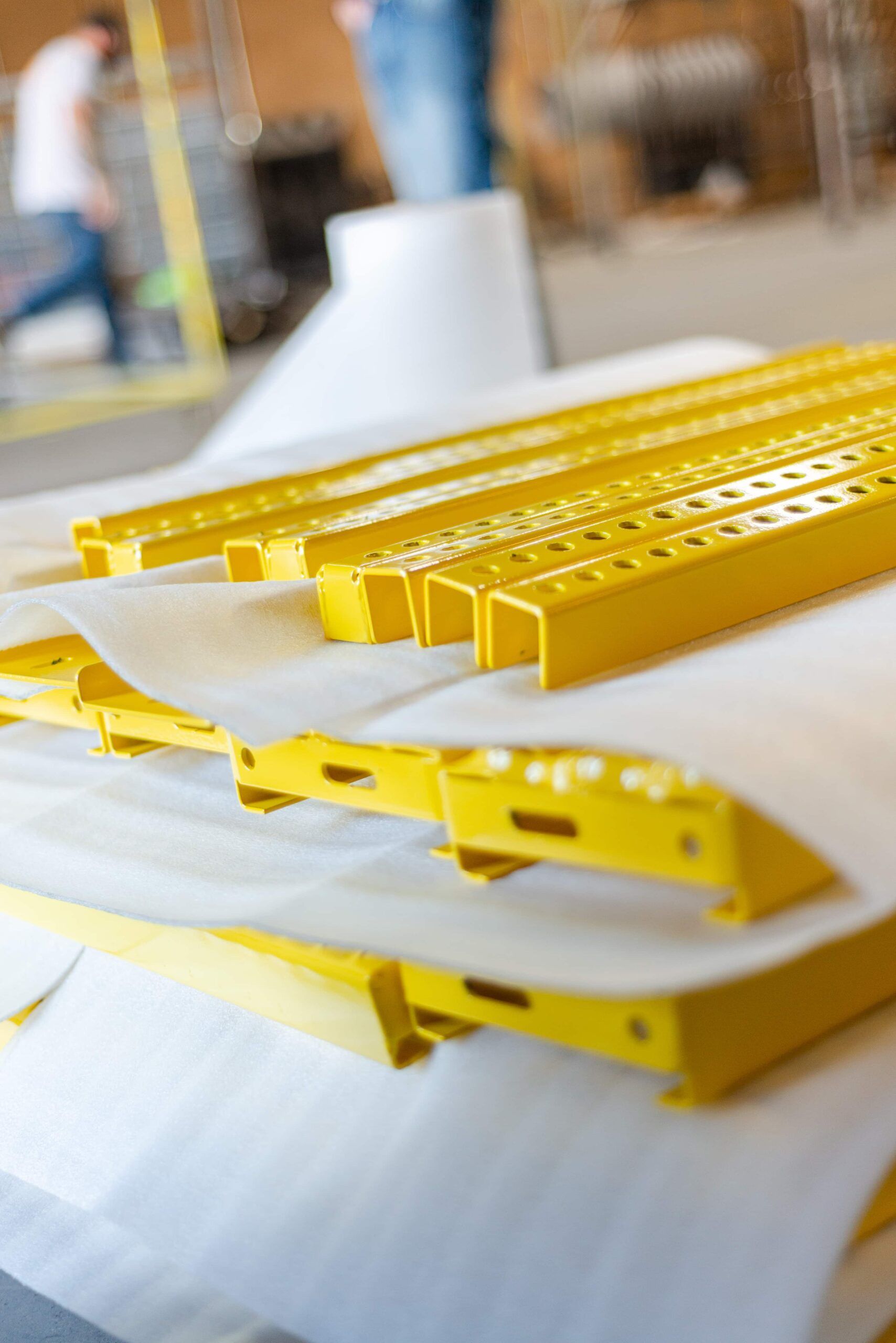 A bunch of yellow metal pieces are sitting on top of each other on a table.