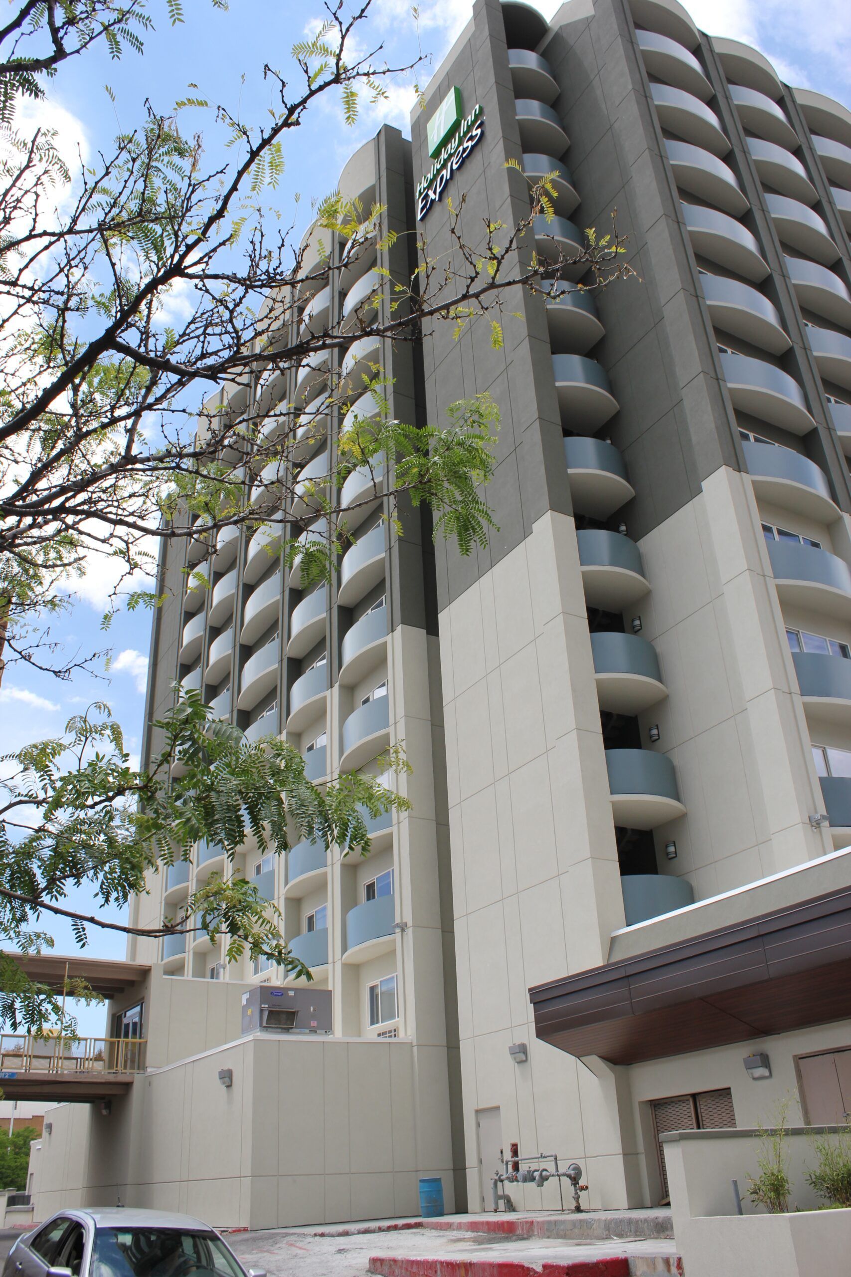 A tall building with a car parked in front of it